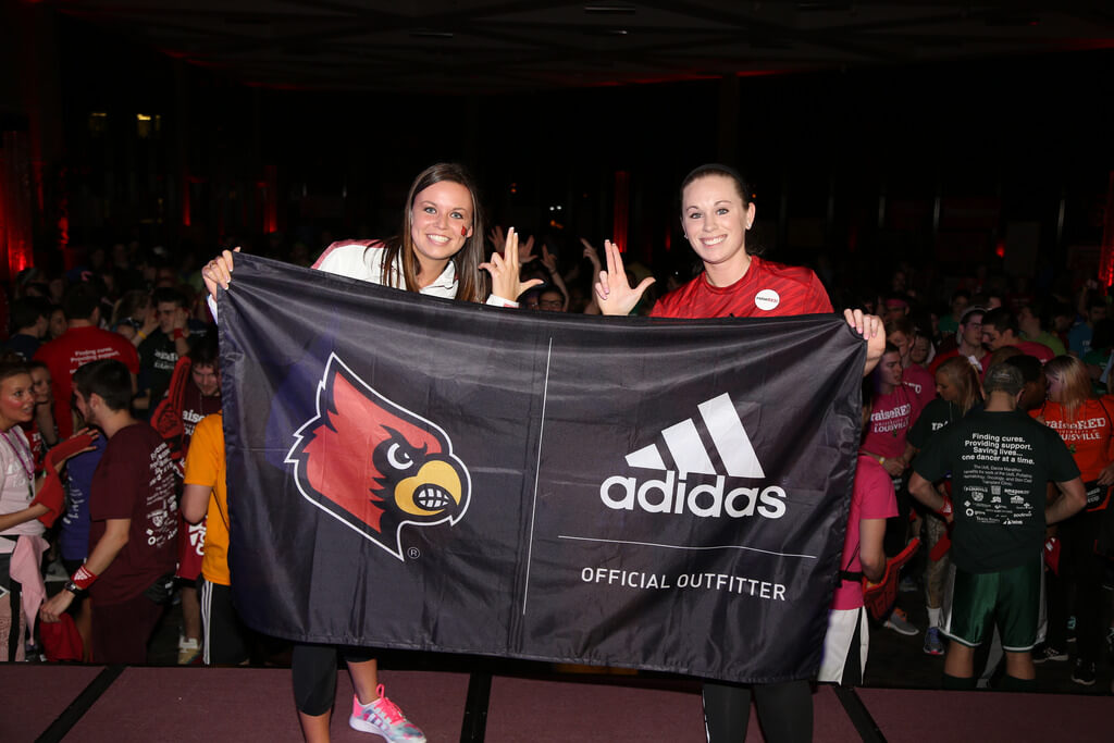 Adidas student brand ambassador holding Cardinals sign