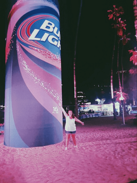 Bud Light brand ambassador in front of a giant can